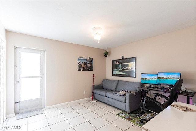 living room featuring baseboards and light tile patterned floors
