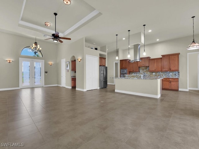 866 Cal Cove Dr, Fort Myers, FL 33919 - unfurnished living room featuring arched walkways, a tray ceiling, a high ceiling, and recessed lighting