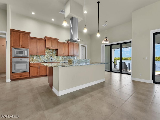866 Cal Cove Dr, Fort Myers, FL 33919 - kitchen with a high ceiling, wall oven, brown cabinets, stainless steel microwave, and island range hood