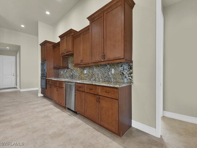 866 Cal Cove Dr, Fort Myers, FL 33919 - kitchen with tasteful backsplash, baseboards, light stone counters, dishwasher, and oven