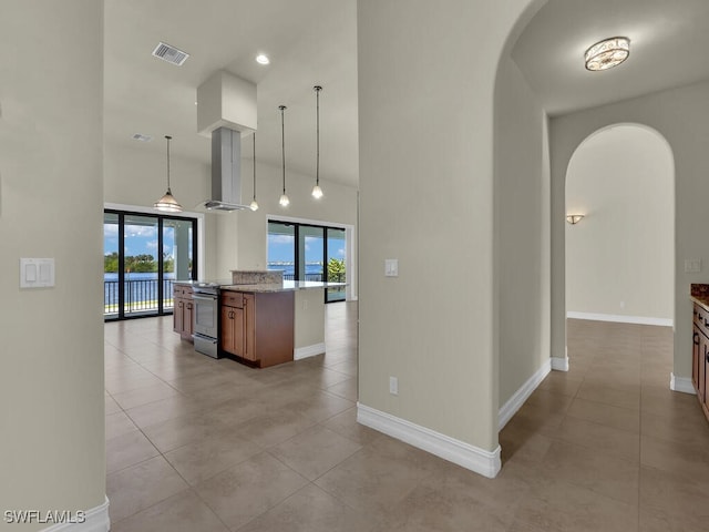 866 Cal Cove Dr, Fort Myers, FL 33919 - kitchen featuring visible vents, arched walkways, a high ceiling, wall chimney range hood, and stainless steel range with electric cooktop
