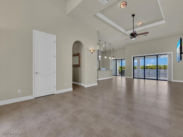 866 Cal Cove Dr, Fort Myers, FL 33919 - unfurnished living room with visible vents, arched walkways, ceiling fan, a tray ceiling, and tile patterned floors