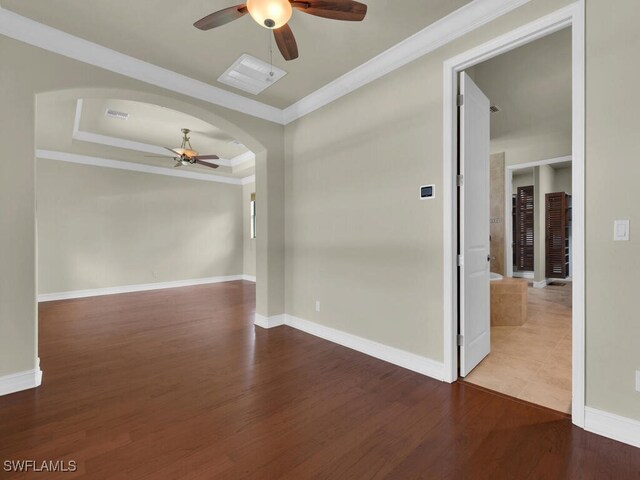 866 Cal Cove Dr, Fort Myers, FL 33919 - empty room with crown molding, a tray ceiling, a ceiling fan, wood finished floors, and baseboards