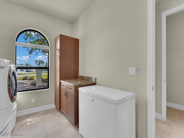 866 Cal Cove Dr, Fort Myers, FL 33919 - washroom featuring light tile patterned floors, separate washer and dryer, baseboards, and cabinet space