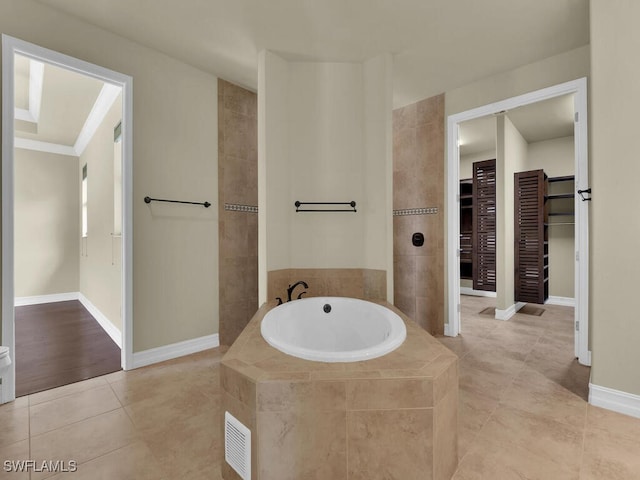 866 Cal Cove Dr, Fort Myers, FL 33919 - bathroom featuring tile patterned floors, a bath, baseboards, and a walk in closet