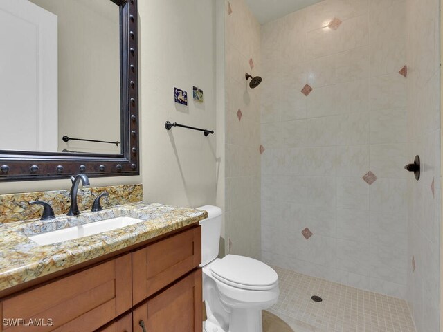 866 Cal Cove Dr, Fort Myers, FL 33919 - bathroom with toilet, tiled shower, and vanity