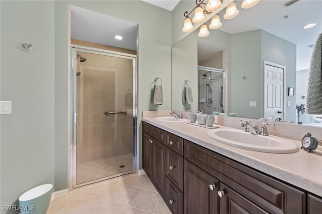 14543 Abaco Lakes Dr Unit 103, Fort Myers, FL 33908 - bathroom featuring a shower stall, tile patterned floors, and double vanity