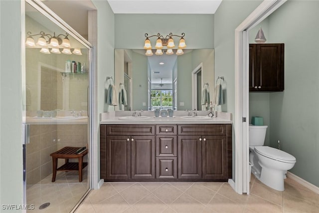 14543 Abaco Lakes Dr Unit 103, Fort Myers, FL 33908 - full bath featuring a stall shower, double vanity, toilet, tile patterned floors, and a chandelier