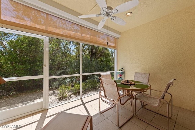 14543 Abaco Lakes Dr Unit 103, Fort Myers, FL 33908 - sunroom featuring a textured wall, healthy amount of natural light, ceiling fan, and tile patterned flooring