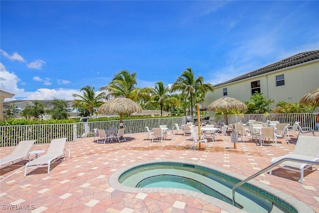14543 Abaco Lakes Dr Unit 103, Fort Myers, FL 33908 - view of pool with fence, a patio area, a community hot tub, and outdoor dining space