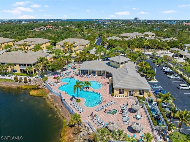 14543 Abaco Lakes Dr Unit 103, Fort Myers, FL 33908 - drone / aerial view of a pool area and a tree filled landscape