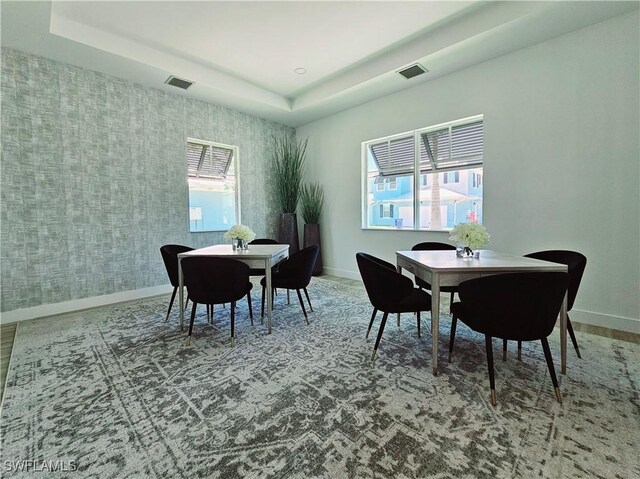 dining area with visible vents, baseboards, and wallpapered walls