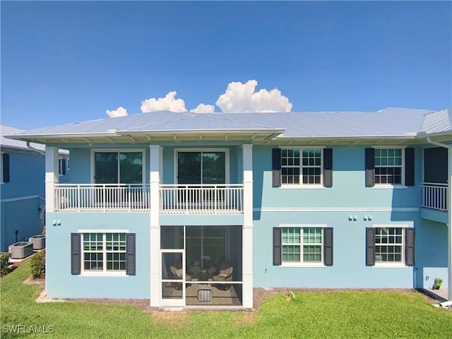 26330 Coco Cay Cir Unit 201, Bonita Springs, FL 34135 - rear view of house featuring stucco siding, a lawn, and a balcony