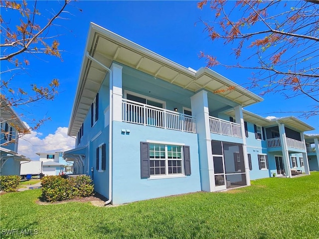 26330 Coco Cay Cir Unit 201, Bonita Springs, FL 34135 - back of property with stucco siding, a yard, and a balcony