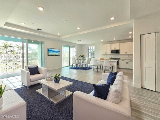 26330 Coco Cay Cir Unit 201, Bonita Springs, FL 34135 - living area featuring a raised ceiling and recessed lighting