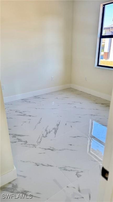 4802 Nora Ave N, Lehigh Acres, FL 33971 - spare room with marble finish flooring and baseboards