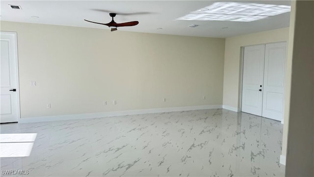 4802 Nora Ave N, Lehigh Acres, FL 33971 - empty room with light marble finish floors and ceiling fan