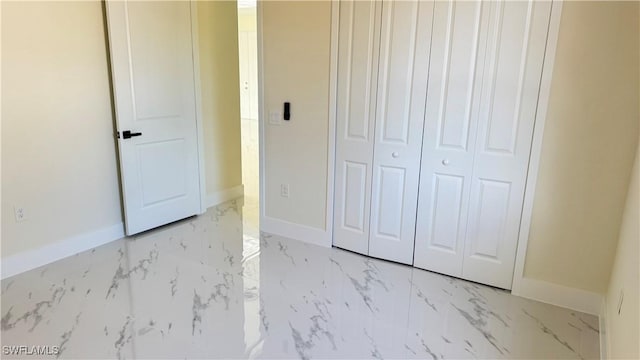4802 Nora Ave N, Lehigh Acres, FL 33971 - unfurnished bedroom featuring light marble finish flooring and a closet