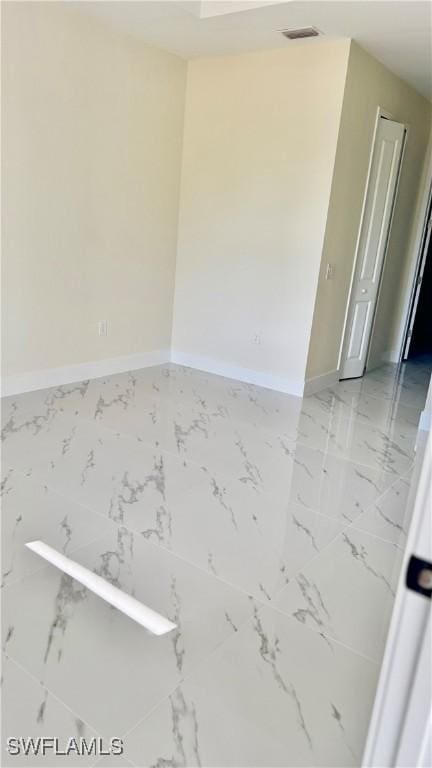 4802 Nora Ave N, Lehigh Acres, FL 33971 - empty room with baseboards and light marble finish flooring
