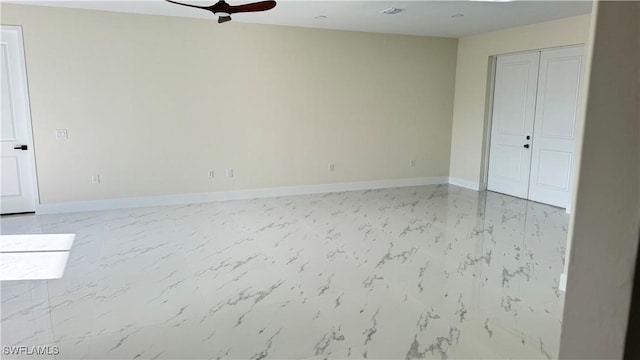 4802 Nora Ave N, Lehigh Acres, FL 33971 - empty room with light marble finish flooring and a ceiling fan