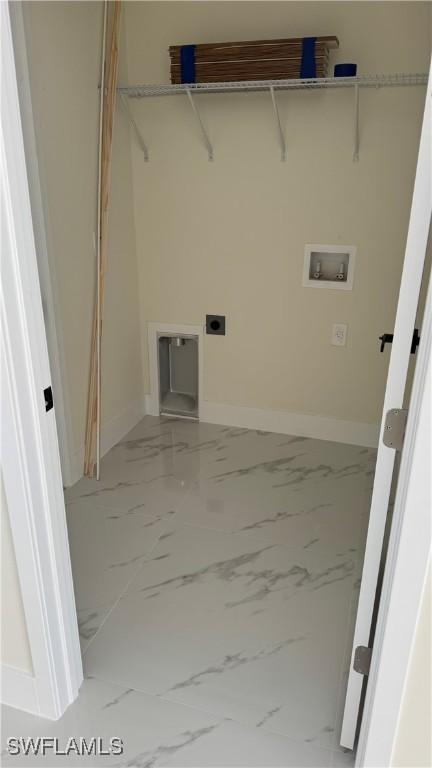 4802 Nora Ave N, Lehigh Acres, FL 33971 - laundry area featuring marble look tile flooring, hookup for a washing machine, and hookup for an electric dryer