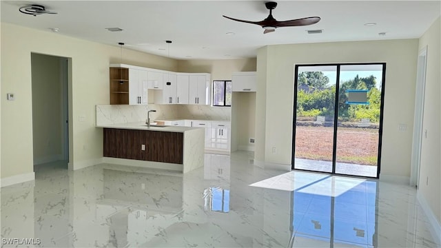 4802 Nora Ave N, Lehigh Acres, FL 33971 - kitchen featuring light marble finish floors, a ceiling fan, white cabinetry, open shelves, and tasteful backsplash