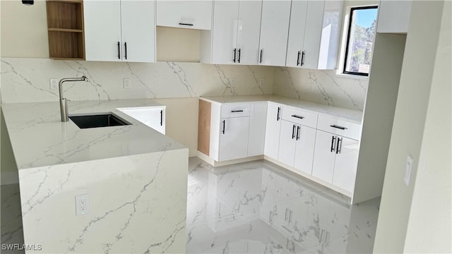 4802 Nora Ave N, Lehigh Acres, FL 33971 - kitchen featuring light stone countertops, light marble finish floors, tasteful backsplash, white cabinetry, and open shelves