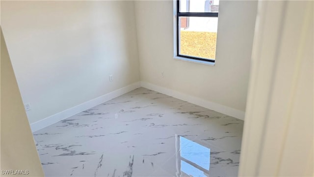 4802 Nora Ave N, Lehigh Acres, FL 33971 - empty room with marble finish flooring and baseboards