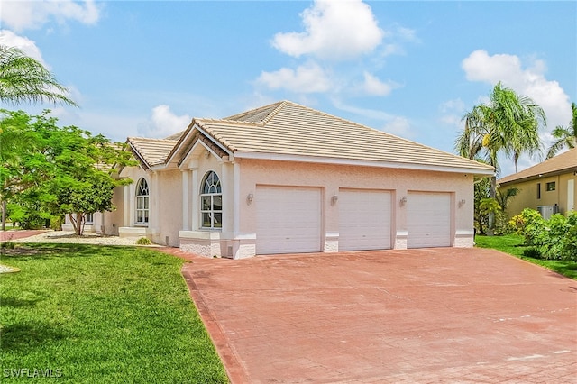 1207 SW 52nd Ter, Cape Coral, FL 33914 - single story home with decorative driveway, stucco siding, a front lawn, a garage, and a tiled roof
