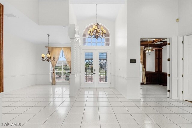 1207 SW 52nd Ter, Cape Coral, FL 33914 - entryway with a chandelier, a high ceiling, light tile patterned floors, french doors, and a ceiling fan