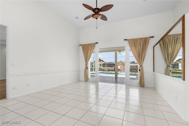 1207 SW 52nd Ter, Cape Coral, FL 33914 - unfurnished room featuring ceiling fan, healthy amount of natural light, light tile patterned flooring, and high vaulted ceiling