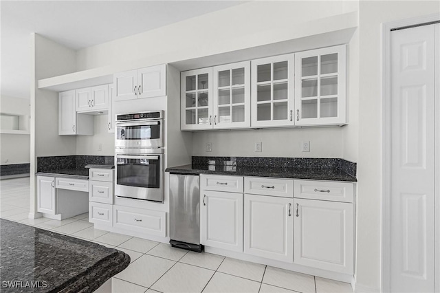 1207 SW 52nd Ter, Cape Coral, FL 33914 - kitchen featuring double oven, glass insert cabinets, white cabinetry, dark stone countertops, and light tile patterned floors