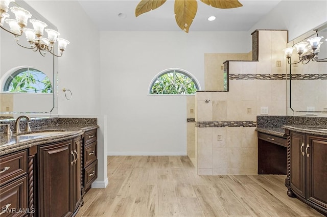1207 SW 52nd Ter, Cape Coral, FL 33914 - bathroom with a chandelier, healthy amount of natural light, two vanities, and a walk in shower