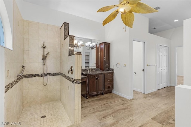 1207 SW 52nd Ter, Cape Coral, FL 33914 - full bath with vanity, a walk in shower, ceiling fan, a chandelier, and wood finished floors