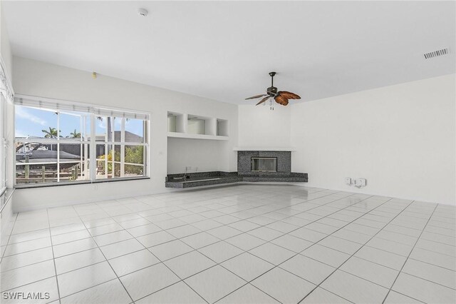 1207 SW 52nd Ter, Cape Coral, FL 33914 - unfurnished living room with a ceiling fan and a fireplace