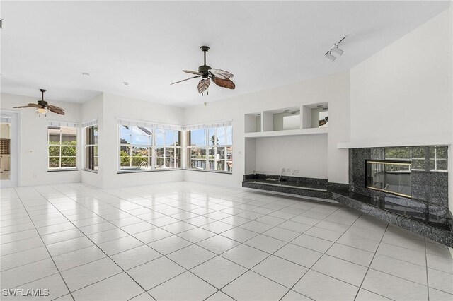 1207 SW 52nd Ter, Cape Coral, FL 33914 - unfurnished living room with a ceiling fan, light tile patterned floors, and a fireplace
