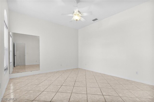 1207 SW 52nd Ter, Cape Coral, FL 33914 - empty room with a ceiling fan, plenty of natural light, and light tile patterned flooring