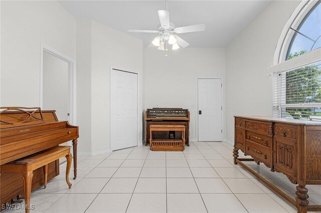 1207 SW 52nd Ter, Cape Coral, FL 33914 - interior space with a ceiling fan, baseboards, light tile patterned floors, and a high ceiling