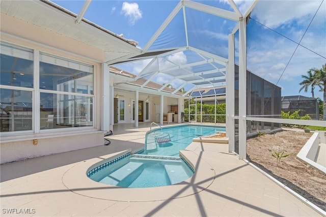 1207 SW 52nd Ter, Cape Coral, FL 33914 - view of pool featuring a patio area, a pool with connected hot tub, and glass enclosure