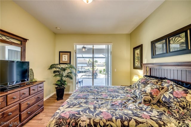3914 SW 17th Ave, Cape Coral, FL 33914 - bedroom featuring baseboards, access to exterior, and light wood-style floors