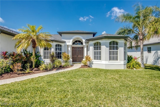 3914 SW 17th Ave, Cape Coral, FL 33914 - view of front facade featuring stucco siding and a front lawn