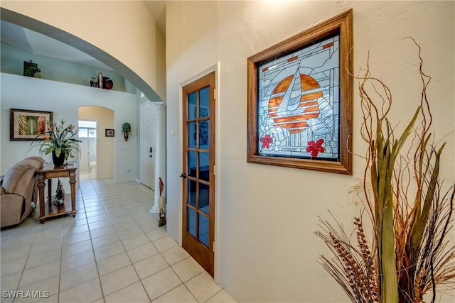 3914 SW 17th Ave, Cape Coral, FL 33914 - hallway with a high ceiling, arched walkways, and light tile patterned floors