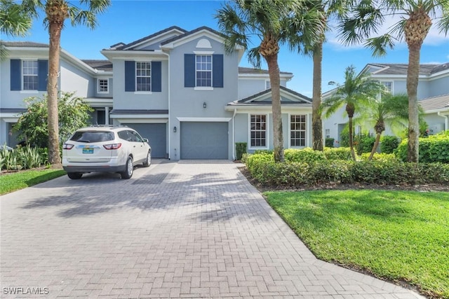 16580 Goldenrod Ln Unit 103, Alva, FL 33920 - traditional home with decorative driveway, an attached garage, and stucco siding