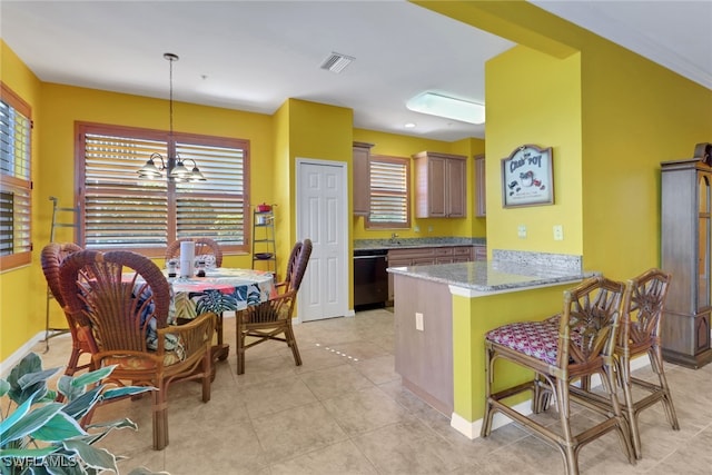 16580 Goldenrod Ln Unit 103, Alva, FL 33920 - kitchen with a wealth of natural light, a chandelier, black dishwasher, and a peninsula