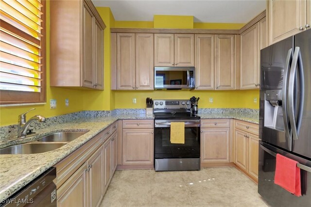 16580 Goldenrod Ln Unit 103, Alva, FL 33920 - kitchen with light stone countertops, a sink, light tile patterned floors, and appliances with stainless steel finishes