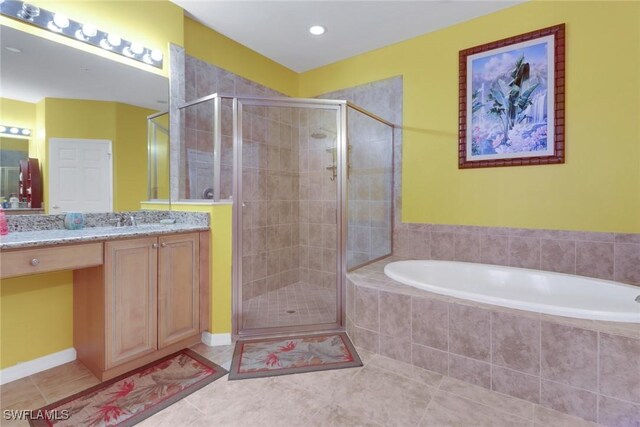 16580 Goldenrod Ln Unit 103, Alva, FL 33920 - bathroom featuring a stall shower, vanity, tile patterned flooring, and a bath