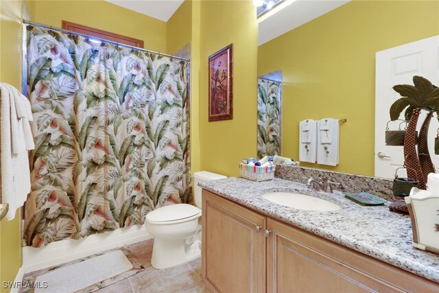 16580 Goldenrod Ln Unit 103, Alva, FL 33920 - full bathroom with tile patterned floors, shower / bath combination with curtain, toilet, and vanity