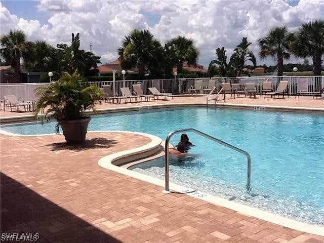 11735 Eros Rd, Lehigh Acres, FL 33971 - community pool with fence and a patio area