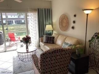 11735 Eros Rd, Lehigh Acres, FL 33971 - tiled living room with a ceiling fan