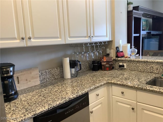 11735 Eros Rd, Lehigh Acres, FL 33971 - kitchen featuring white cabinets, light stone countertops, and dishwasher